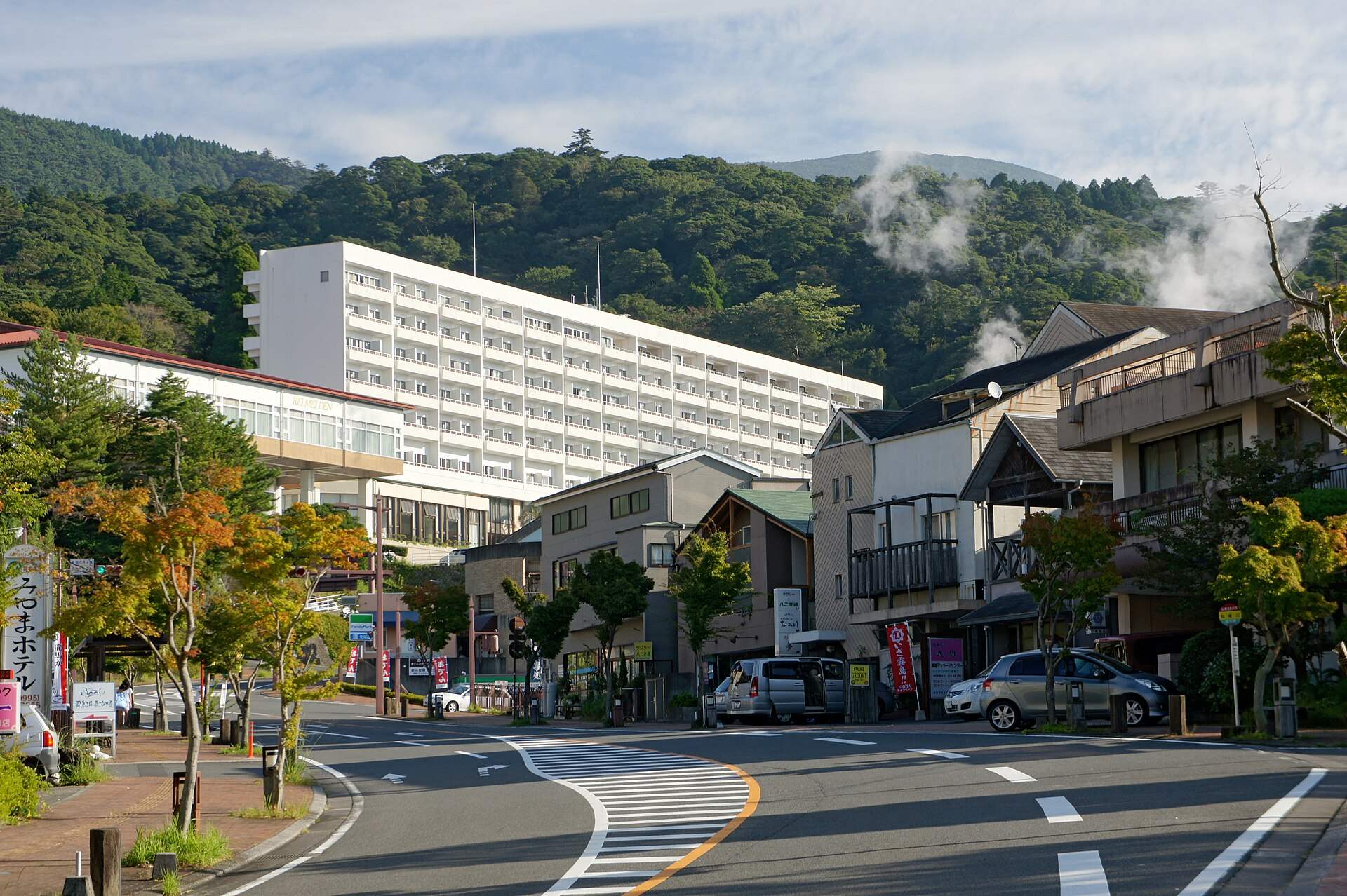 湯けむりの上がる丸尾温泉の通りとホテル