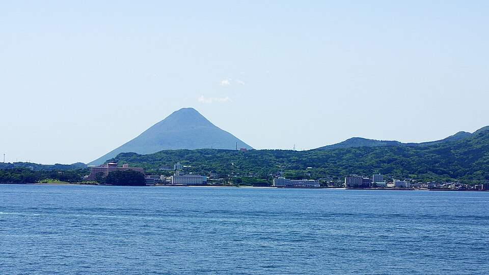 海から見た指宿温泉の街並みと開聞岳